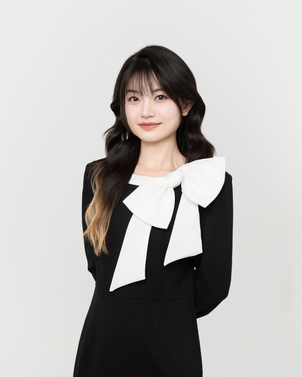Portrait of Serena Zhang in a black dress with a white bow